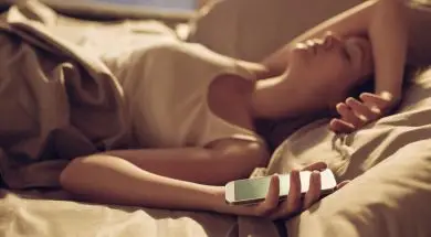 Woman alseep next to smart phone