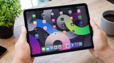 Man hand holding iPad Air IOS 14 widget home screen