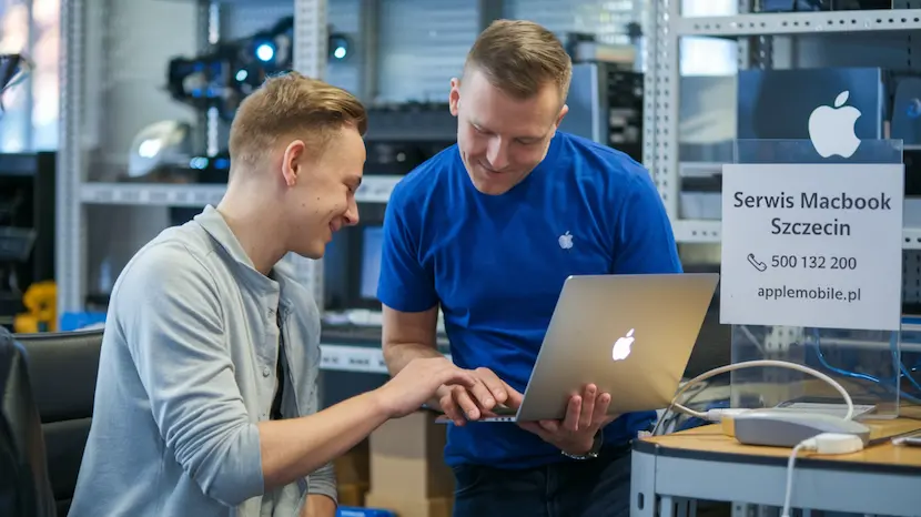 Doświadczony doradca serwisu APPLEMOBILE w Szczecinie wydający zadowolonemu klientowi naprawionego MacBooka po wymianie spuchniętej baterii